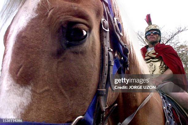 Man dressed as a Roman on horseback 21 April 2000 participates in a Holy Week procession in Old Guatemala. Un hombre sobre un caballo vestido de...