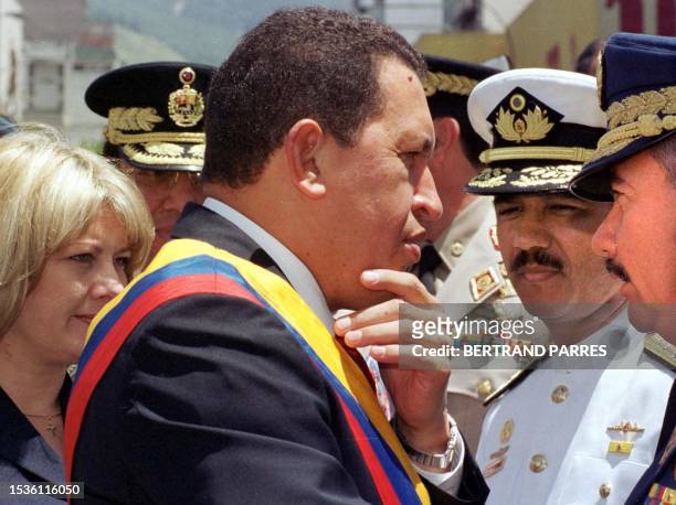 Venezuelan President Hugo Chavez Frias , with his wife Marisabel , speaks with Venezuelan officials before a civilian-military parade to commemorate...