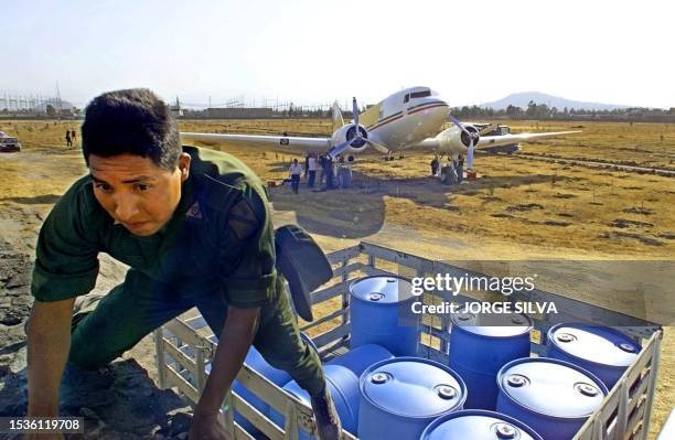 Mexican Soldier tries to impede the photographing of a bi-engine plane that crashed in the city of Mexico, 03 February, 2000. Authorities at the...