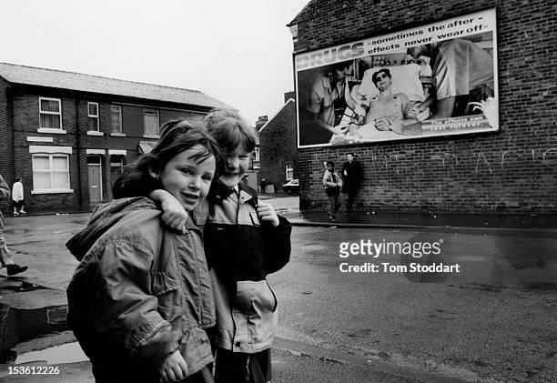 Children pass a poster warning of the dangers of drugs in the Claremont Road area of Moss Side, south Manchester. During the 1980's the area suffered...