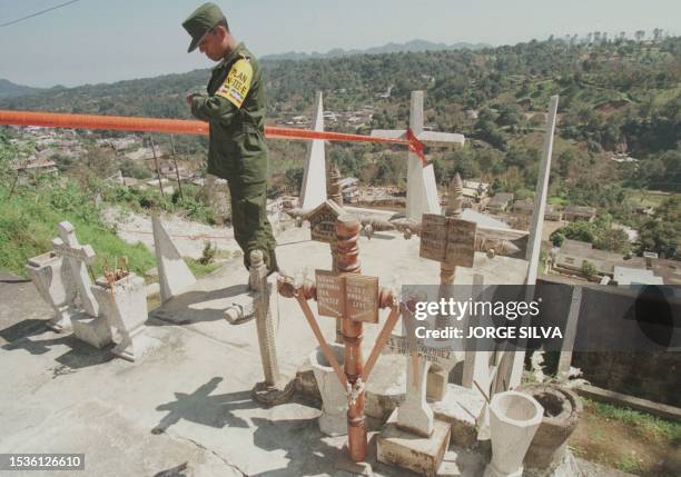 Soldier guards an area of the Teziutlan pantheon on the day of the Dead in Puebla, Mexico, 01 November 1999. Un soldado vigila una zona del panteon...