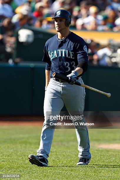 Casper Wells of the Seattle Mariners returns to the dugout after striking out against the Oakland Athletics during the ninth inning at O.co Coliseum...