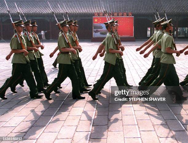 Chinese soldiers march with bayonettes at their barracks near Tianamen Square, 03 June 1999 in Beijing. Security around the square remains tight as...