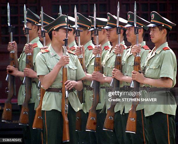 Chinese People's Liberation Army soldiers practice with their bayonettes during training at their barracks near Beijing's Tiananmen Square 02 June...