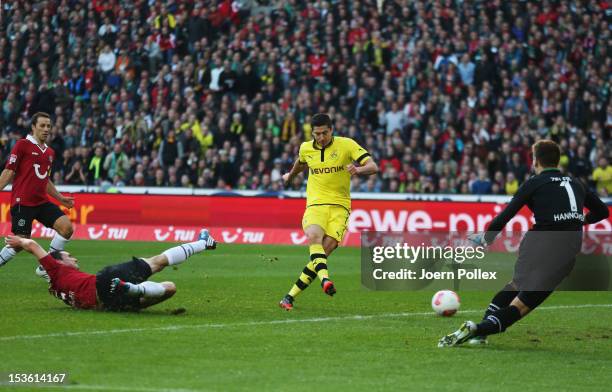 Robert Lewandowski of Dortmund scores his team's first goal during the Bundesliga match between Hannover 96 and Borussia Dortmund at AWD Arena on...