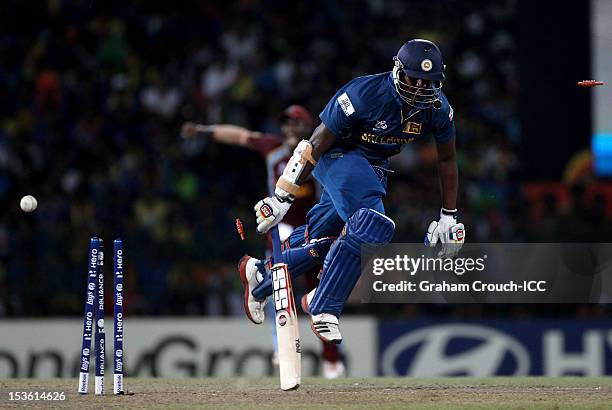 Thisara Perera of Sri Lanka is run out by Denesh Ramdin of West Indies during the ICC World Twenty20 2012 Final between Sri Lanka and West Indies at...