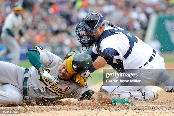 Coco Crisp of the Oakland Athletics is tagged out at home Gerald Laird of the Detroit Tigers in the top of the third inning during Game Two of the...