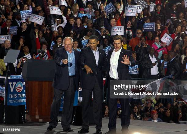 From fore, left, American politicians Illinois governor Pat Quinn, US President Barack Obama, and Senate candidate Alexi Giannoulias wave from the...