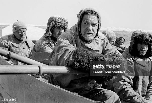 British actor Kenneth Branagh and cast members filming a scene in a rowing boat on location in Greenland for the TV serial 'Shackleton', directed by...