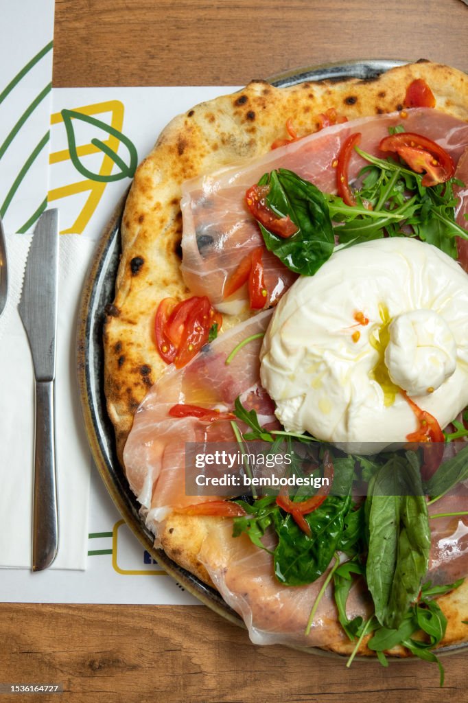 Neapolitan pizza with burrata mozzarella and cherry tomatoes