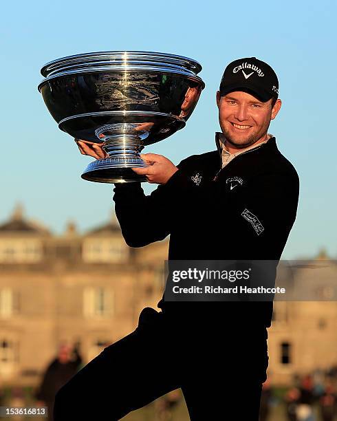Branden Grace of South Africa holds the trophy aloft on the Swilken Bridge after his victory in The Alfred Dunhill Links Championship at The Old...