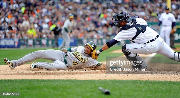 Coco Crisp of the Oakland Athletics is tagged out at home Gerald Laird of the Detroit Tigers in the top of the third inning during Game Two of the...