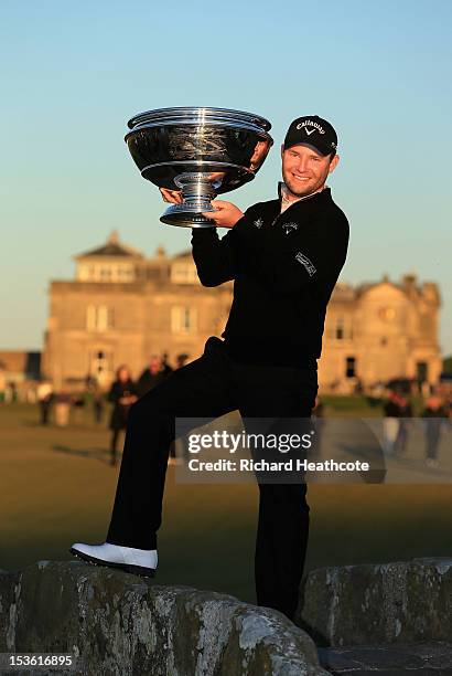 Branden Grace of South Africa holds the trophy aloft on the Swilken Bridge after his victory in The Alfred Dunhill Links Championship at The Old...