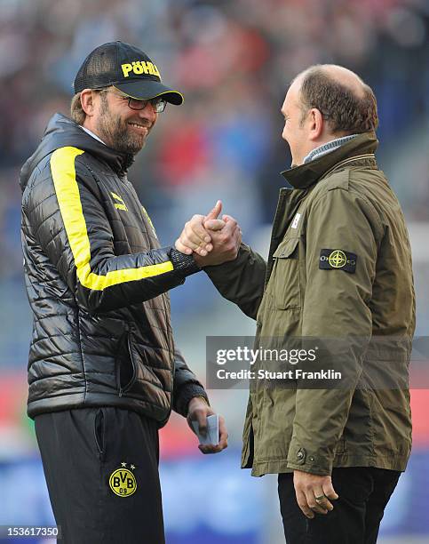 Juergen Klopp, head coach of Dortmund greets Joerg Schmadtke, manager of Hannover during the Bundesliga match between Hannover 96 and Borussia...