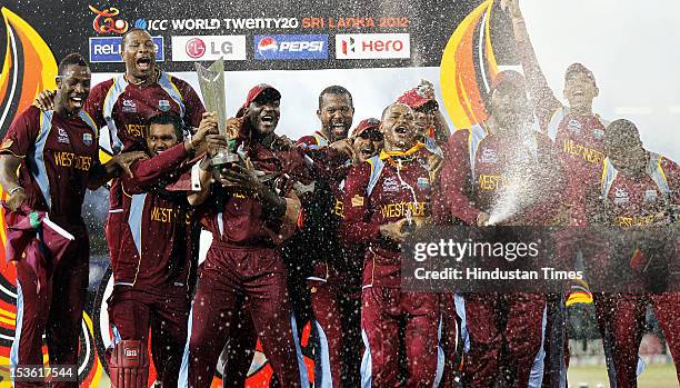 West Indies celebrate with the trophy after winning the ICC World T20 cricket final match against Sri Lanka at R. Premadasa Stadium on October 7,...