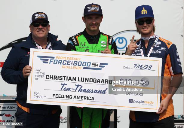 Christian Lundgaard receives a cheque after winning the Honda Indy Toronto Grand Prix in Toronto, Ontario on July 16, 2023.
