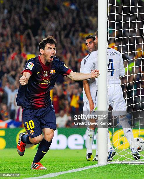 Lionel Messi of FC Barcelona celebrates after scoring his team's first goal during the La Liga match between FC Barcelona and Real Madrid CF at Camp...
