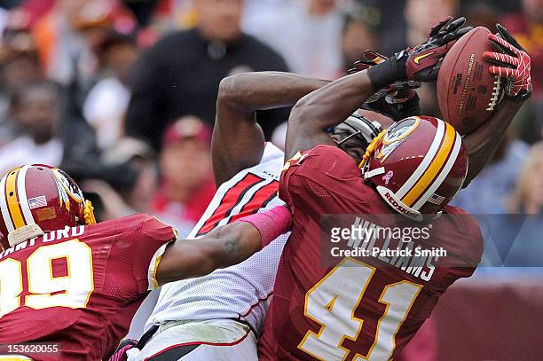 Wide receiver Julio Jones of the Atlanta Falcons and safety Madieu Williams of the Washington Redskins fight for a pass in the end zone that was...
