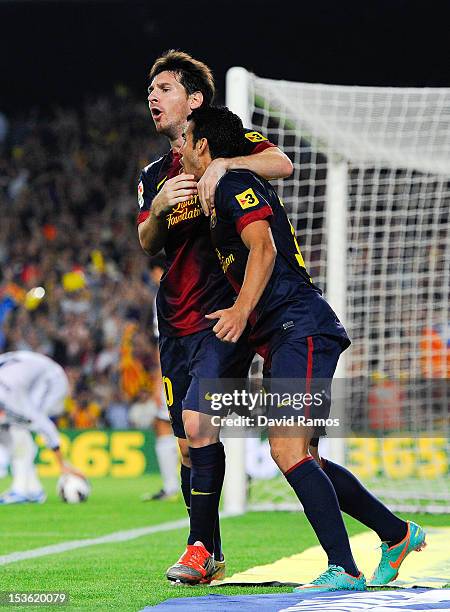 Lionel Messi of FC Barcelona celebrates with his teammate Pedro Rodriguez after scoring his team's first goal during the La Liga match between FC...