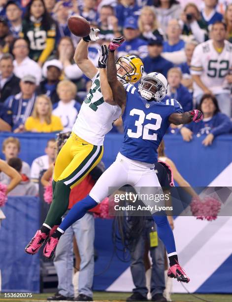 Cassius Vaughn of the Indianapolis Colts and Jordy Nelson of the Green Bay Packers reach for a pass during the NFL game at Lucas Oil Stadium on...