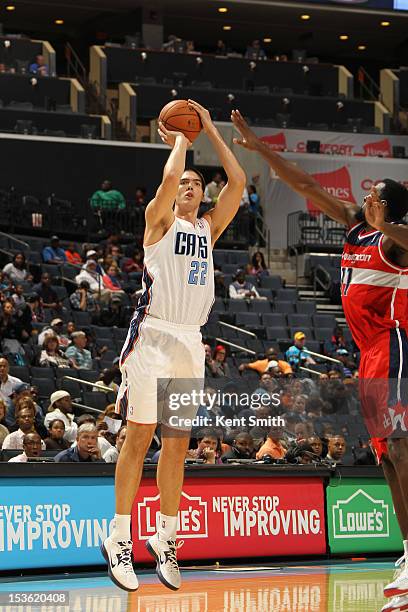 Byron Mullens of the Charlotte Bobcats shoots against the Washington Wizards at the Time Warner Cable Arena on October 7, 2012 in Charlotte, North...