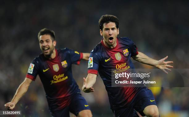 Lionel Messi of Barcelona celebrates scoring beside his teammate Jordi Alba during the la Liga match between FC Barcelona and Real Madrid at the Camp...