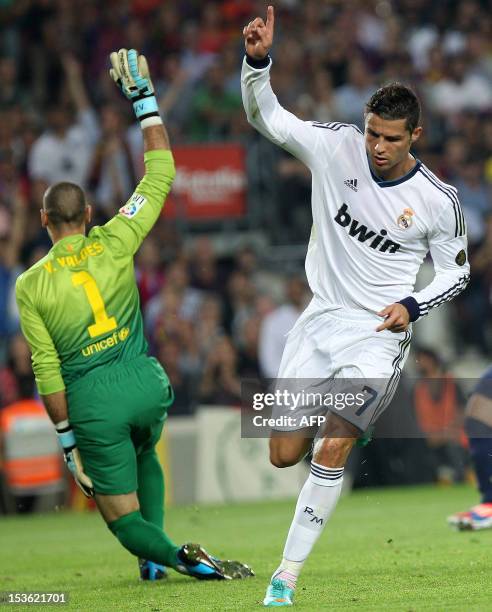 Real Madrid's Portuguese forward Cristiano Ronaldo celebrates after scoring his second goal past Barcelona's goalkeeper Victor Valdes during the...