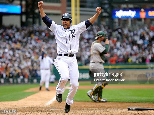 Omar Infante of the Detroit Tigers celebrates as he scores the game-winning run on a sacrifice fly hit by Don Kelly in the bottom of the ninth inning...
