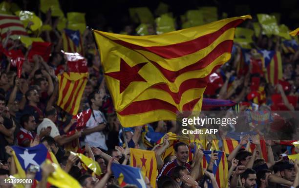 Barcelona's football fans wave "Estelada", the Catalan independentist flag during the Spanish League Clasico football match FC Barcelona vs Real...