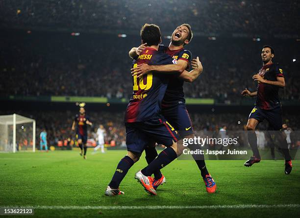 Lionel Messi of Barcelona celebrates scoring with his teammate Jordi Alba during the la Liga match between FC Barcelona and Real Madrid at the Camp...