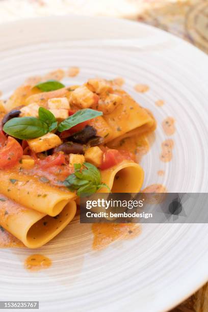 pasta dish with tomatoes and fish - amberjack stock pictures, royalty-free photos & images