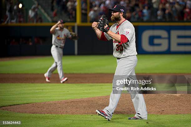 Pitcher Jason Motte of the St. Louis Cardinals celebrates his team's win against the Atlanta Braves during the National League Wild Card Game at...