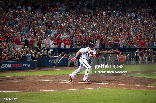 Chipper Jones of the Atlanta Braves runs to first in his last Major League Baseball at bat during the National League Wild Card Game against the St....