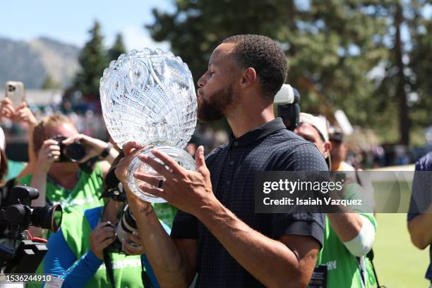 Stephen Curry of the NBA Golden State Warriors kisses the trophy after winning the championship on Day Three of the 2023 American Century...