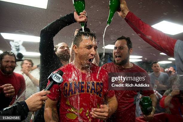 Pitcher Kyle Lohse of the St. Louis Cardinals is doused with champagne in the clubhouse as the Cardinals celebrate their win over the Atlanta Braves...