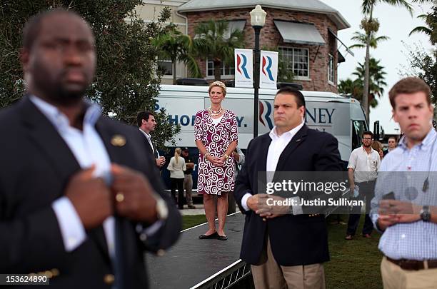 Secret Service agents and campaign staffers look on as Ann Romney watches her husband, Republican presidential candidate, former Massachusetts Gov....
