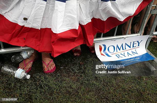 Supporter of Republican presidential candidate, former Massachusetts Gov. Mitt Romney stands in mud during a victory rally at Tradition Town Square...