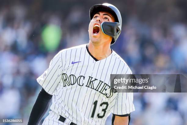 Alan Trejo of the Colorado Rockies celebrates after hitting a walk-off home run to beat the New York Yankees in the eleventh inning at Coors Field on...