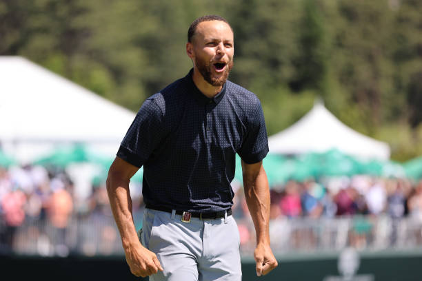 Stephen Curry of the NBA Golden State Warriors reacts after making the final putt on the 18th hole to win the American Century Championship on Day...
