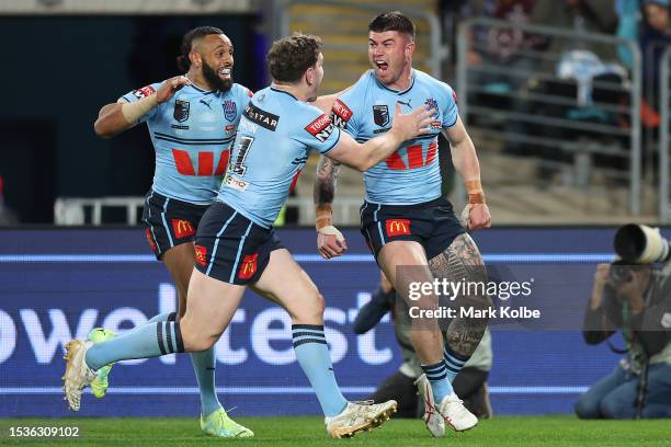 Bradman Best of the Blues celebrates with team mates after scoring a try during game three of the State of Origin series between New South Wales...