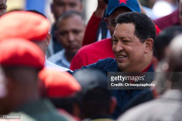 President Hugo Chavez waves supporters as he arrives to vote in the presidential elections. Chavez seeks reelection against the candidate of the MUD...