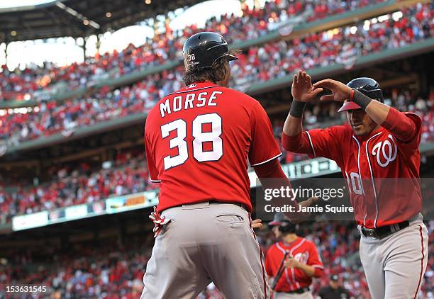 Michael Morse and Ian Desmond of the Washington Nationals celebrate after scoring the tying and go ahead runs in the eighth inning against the St...