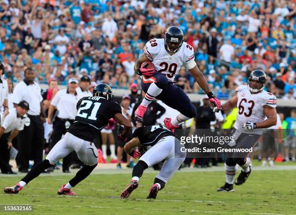 Michael Bush of the Chicago Bears jumps over Chris Prosinski of the Jacksonville Jaguars during the game at EverBank Field on October 7, 2012 in...