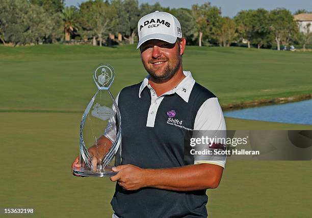 Ryan Moore poses with the trophy on the 18th green after winning the Justin Timberlake Shriners Hospitals for Children Open at TPC Summerlin on...