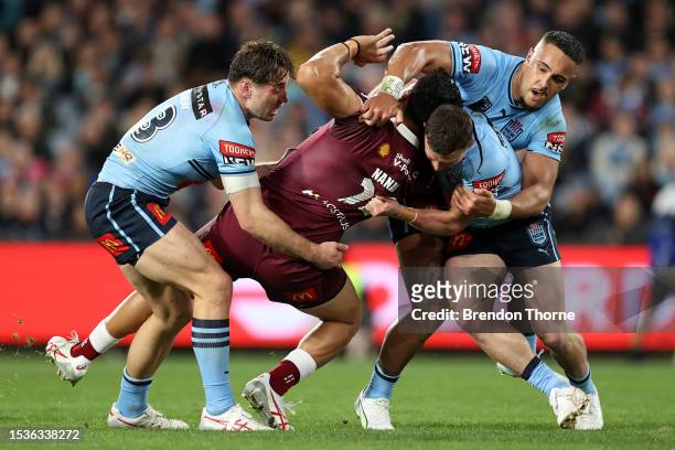 Jeremiah Nanai of the Maroons is tackled by Cameron Murray, Damien Cook and Keaon Koloamatangi of the Blues during game three of the State of Origin...