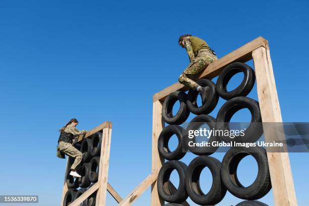 Participants practice an obstacle course exercise on a training ground of one of the military battalions during the final testing of women's army...