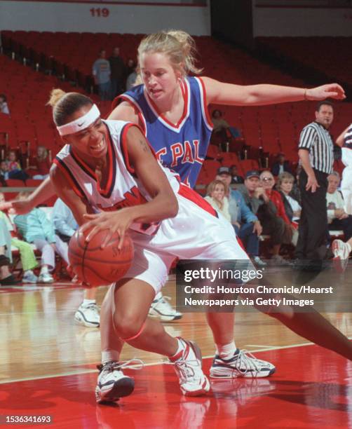 Of H's Monet Sykes takes control of the ball from DePaul's Sarah Kustok during Houston's victory over the DePaul Blue Demons. HOUCHRON CAPTION :...