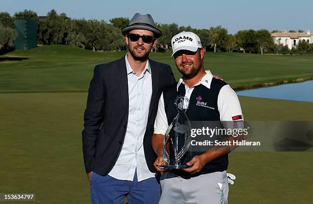 Ryan Moore poses with tournament host Justin Timberlake and the trophy after winning the Justin Timberlake Shriners Hospitals for Children Open at...