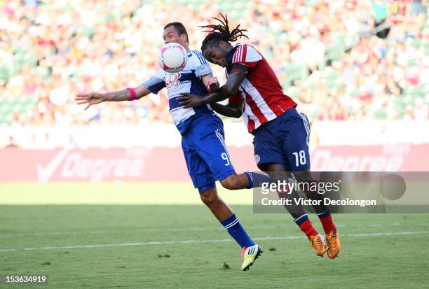 Blas Perez of FC Dallas and Shalrie Joseph of Chivas USA vie for the ball in the first half during the MLS match at The Home Depot Center on October...