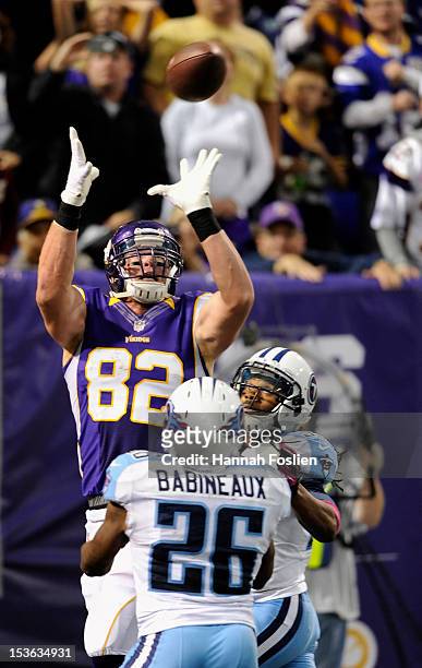 Kyle Rudolph of the Minnesota Vikings makes a catch for a touchdown over Jordan Babineaux and Michael Griffin of the Tennessee Titans during the...